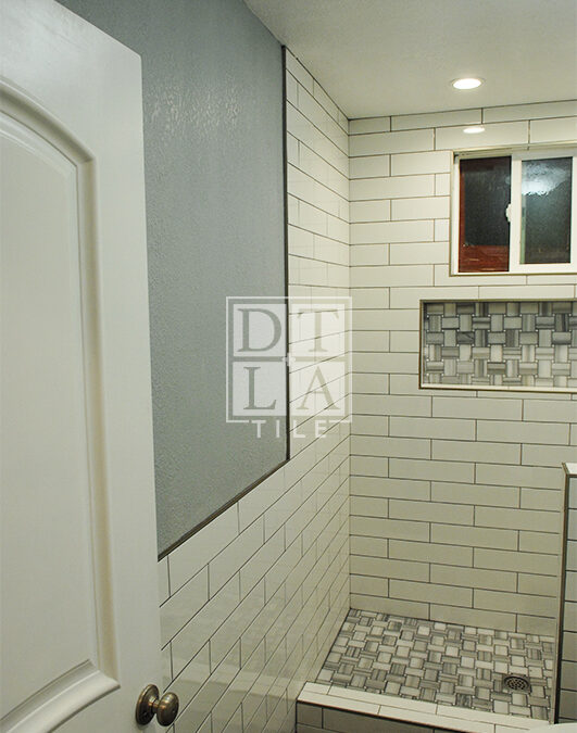 Installation of tile on a floor & wall in Compton bathroom