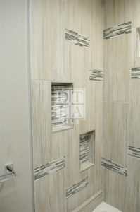 Mosaic inserts and custom shampoo niches with Schluter Trim