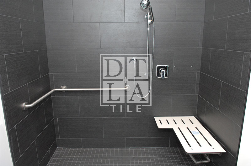 Front view of tile installation in Silveralake Handicap shower with Bobrick handicap bench in open position